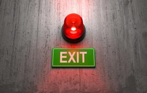 Emergency light and exit text on the wall for safety compliance