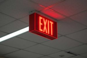 Emergency exit light showcasing the way to exit while danger