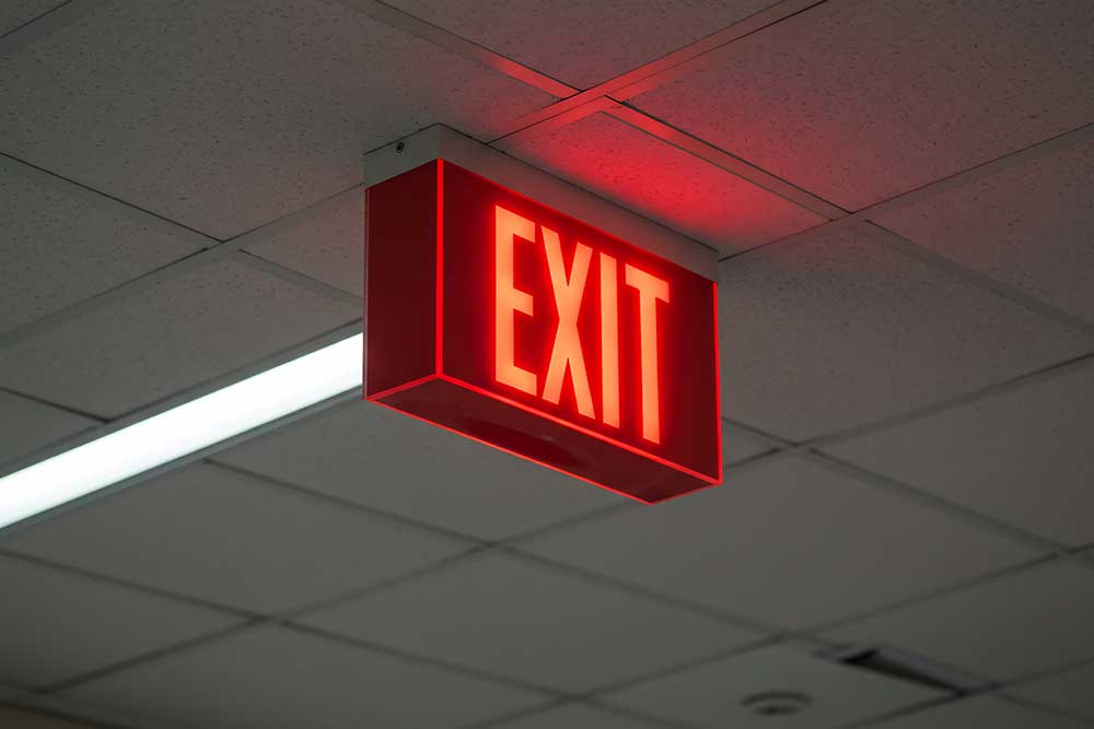 Emergency exit light showcasing the way to exit while danger