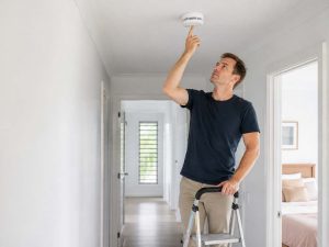 Homeowner upgrading to interconnected photoelectric smoke alarms with products from Fire Factory Queensland